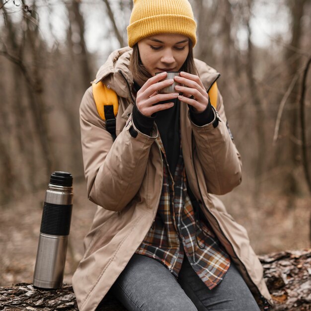 Medium shot woman sitting with cup