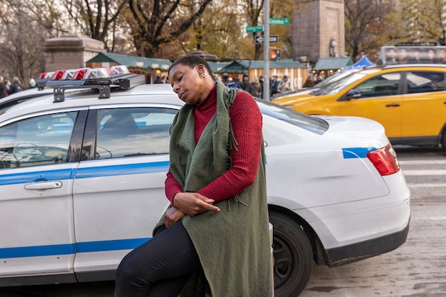 Medium shot woman sleeping near car