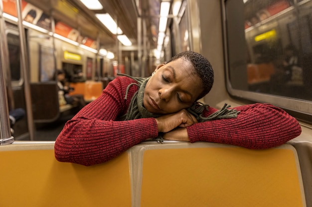 Medium shot woman sleeping in public space