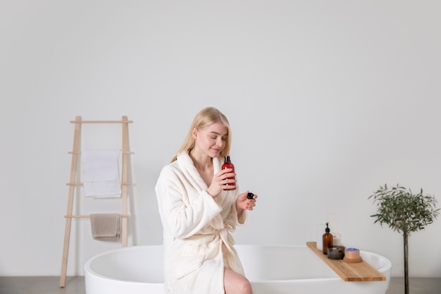 Medium shot woman smelling product