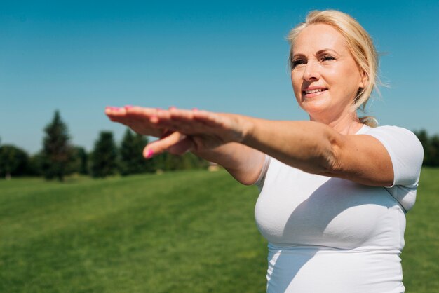 Medium shot woman stretching arms out front