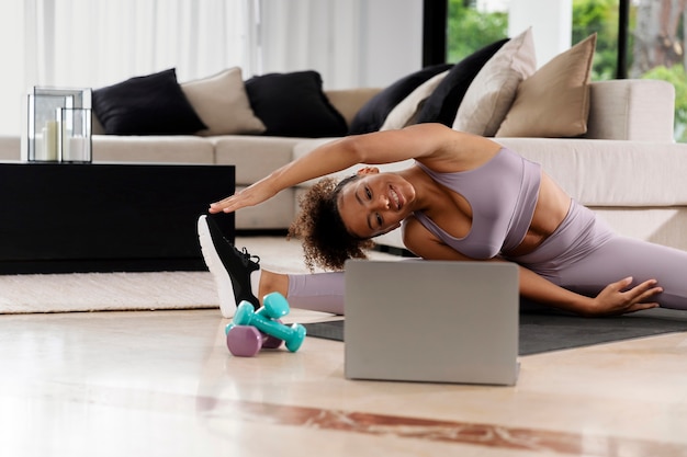 Medium shot woman stretching at home