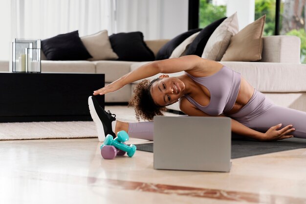 Medium shot woman stretching at home