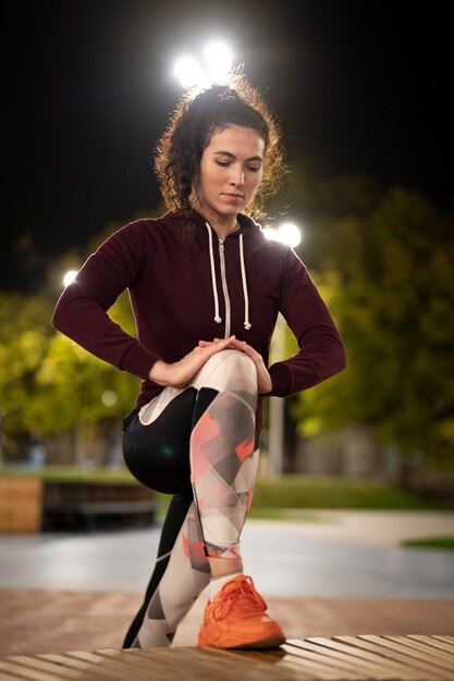 Medium shot woman stretching leg