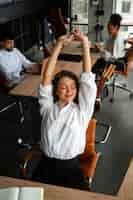 Free photo medium shot woman stretching at work