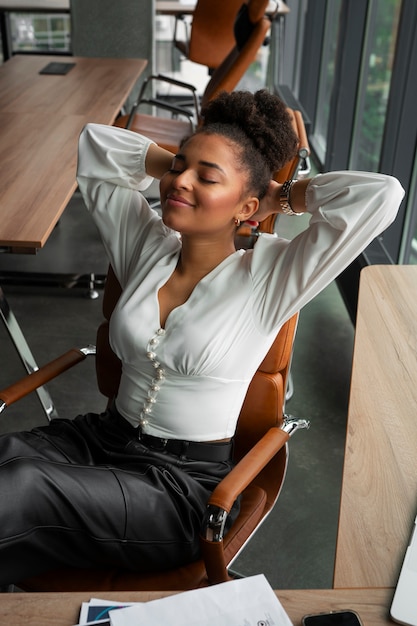 Free photo medium shot woman stretching at work