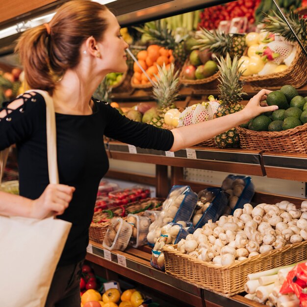 medium shot woman taking an avocado