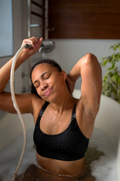 Free photo medium shot woman taking bath