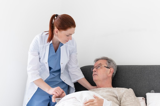medium shot woman taking care of man