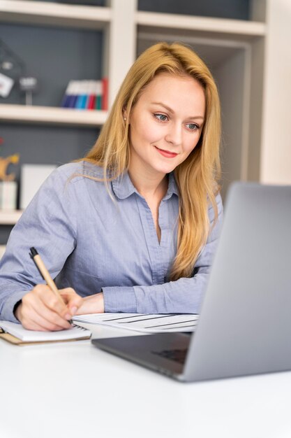 Medium shot woman taking notes