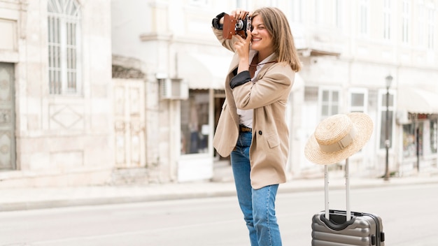 Medium shot woman taking photos