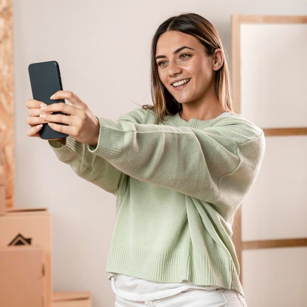 Medium shot woman taking selfie