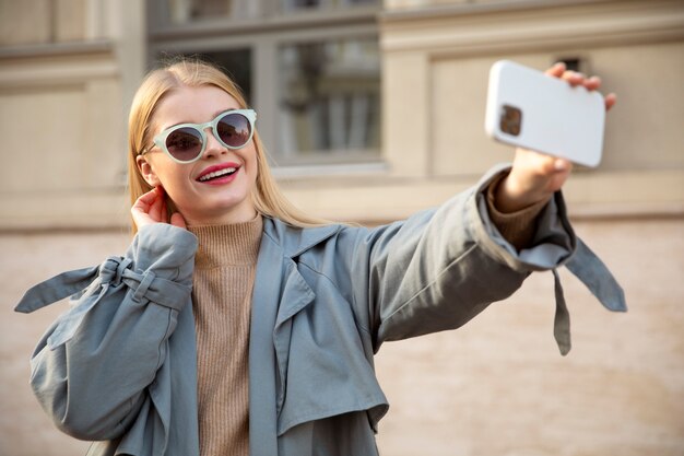 Medium shot woman taking selfie