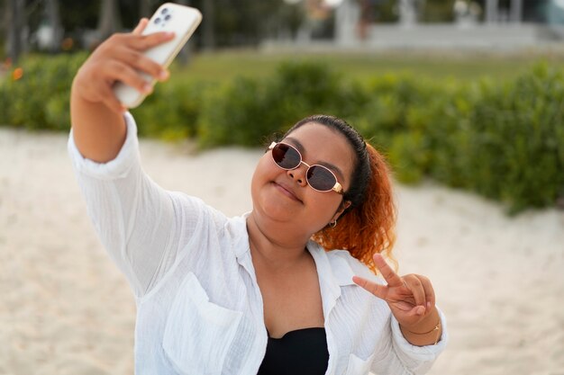 Medium shot woman taking selfie