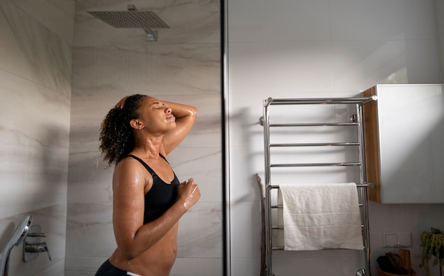 Medium shot woman taking shower