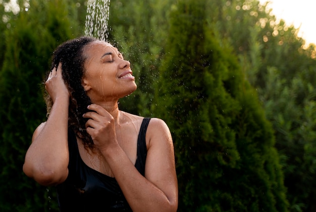 Free photo medium shot woman taking shower