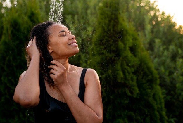 Medium shot woman taking shower