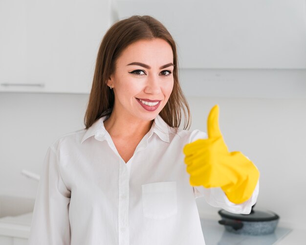 Medium shot of woman and thumbs up wearing gloves