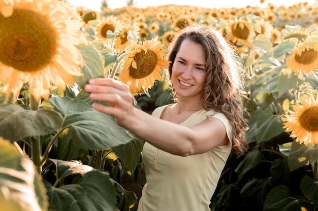 Medium shot woman touching leaf