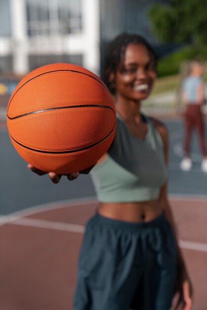 Medium shot woman training for basketball
