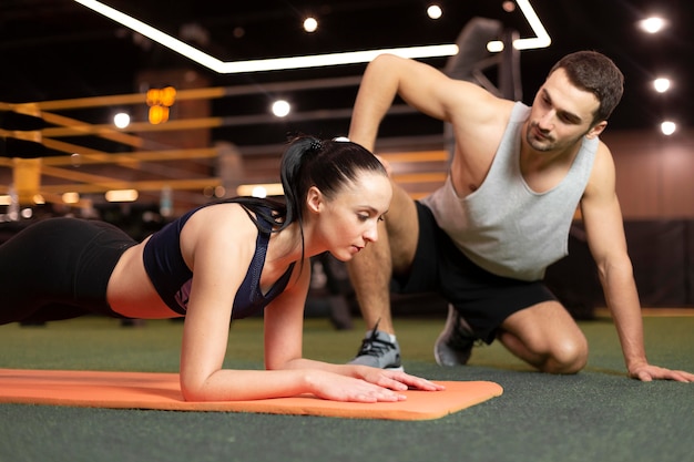 Medium shot woman training on mat