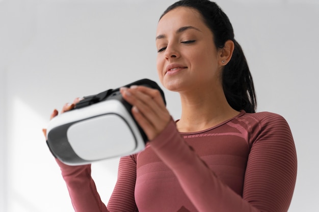 Free photo medium shot woman training with vr glasses on