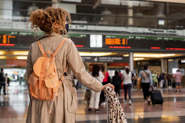 Medium shot woman traveling with mask