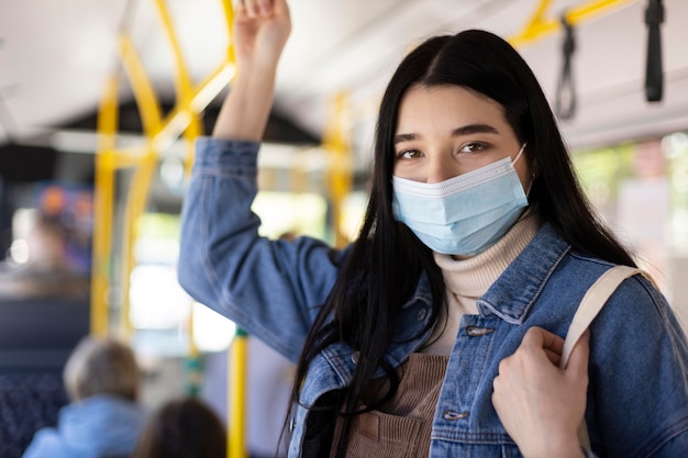 Free photo medium shot woman traveling with mask