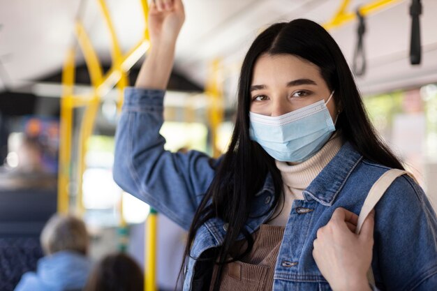 マスクをして旅行するミディアムショットの女性