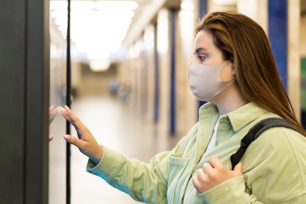 Medium shot woman traveling with mask