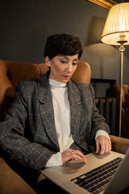 Medium shot woman typing on laptop