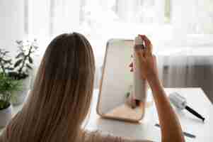 Free photo medium shot woman using dry shampoo at home