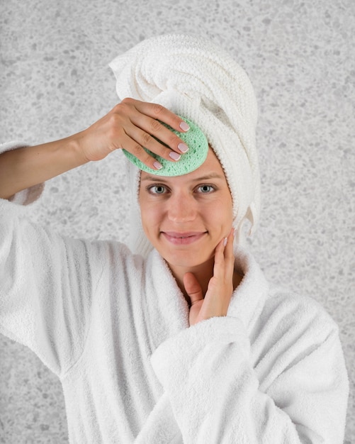 Medium shot woman using green sponge