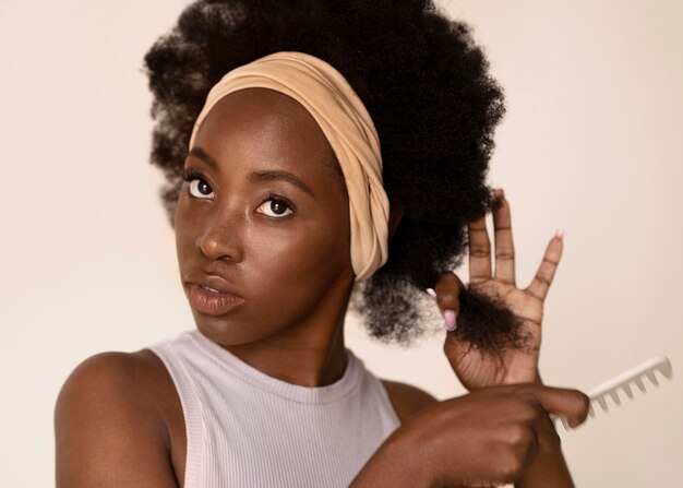 Medium shot woman using hair comb