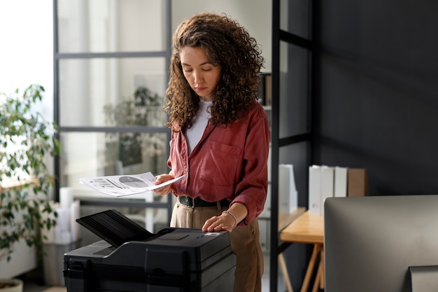 Free photo medium shot woman using printer