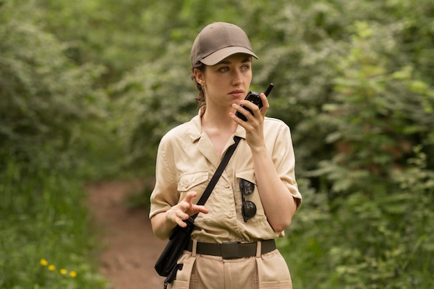 Medium shot woman using walkie talkie