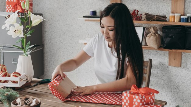 Medium shot woman using wrapping paper