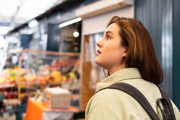 Free photo medium shot woman walking with backpack