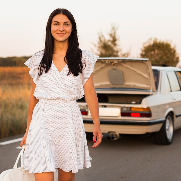 Free photo medium shot woman walking with bag