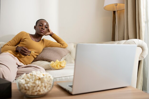 Medium Shot Woman Watching Movie On Laptop