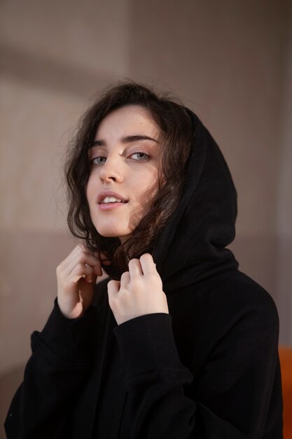 Medium shot woman wearing black hoodie