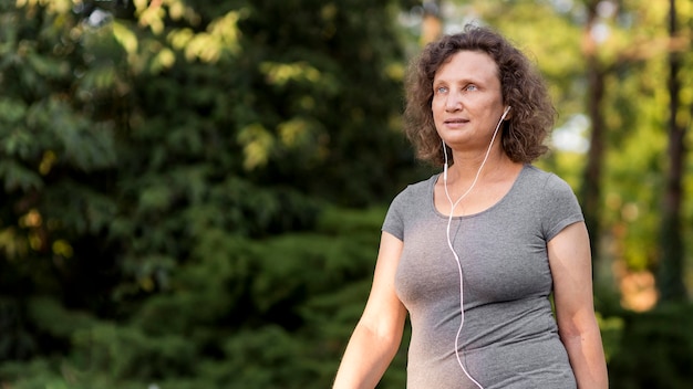 Medium shot woman wearing earphones