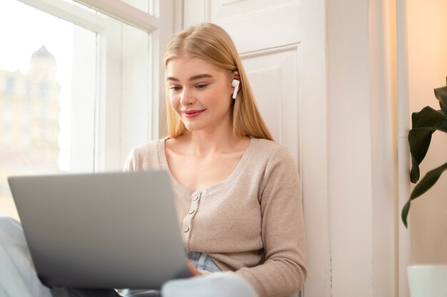 Medium shot woman wearing earphones