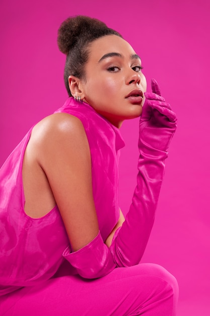 Medium shot woman wearing full pink outfit