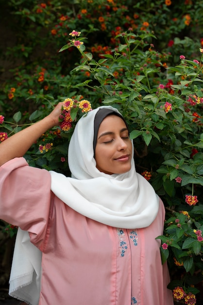 Medium shot woman wearing halal outdoors