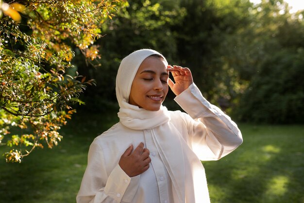 Medium shot woman wearing halal outdoors
