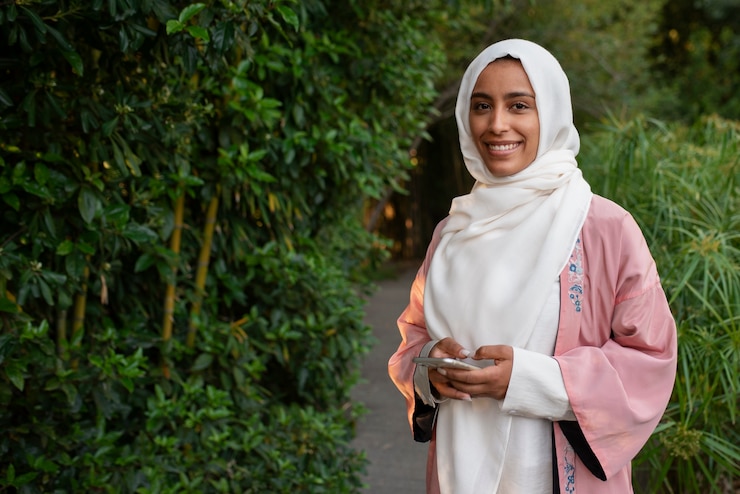 Free Photo medium shot woman wearing halal outdoors