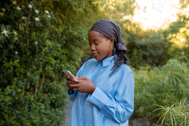 Free photo medium shot woman wearing halal outdoors