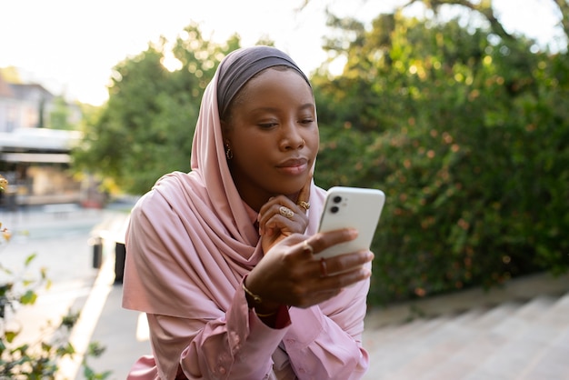 Medium shot woman wearing halal outdoors