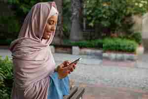 Free photo medium shot woman wearing halal outdoors